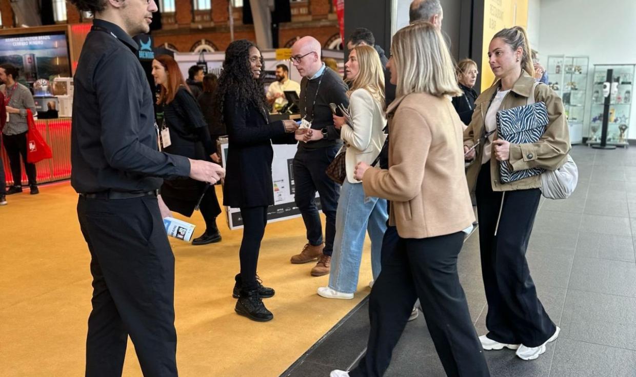 Individuals walking into exhibition space in large Central Hall at NRB